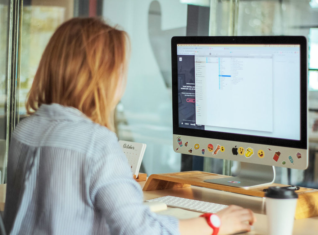 girl working on computer at her desk